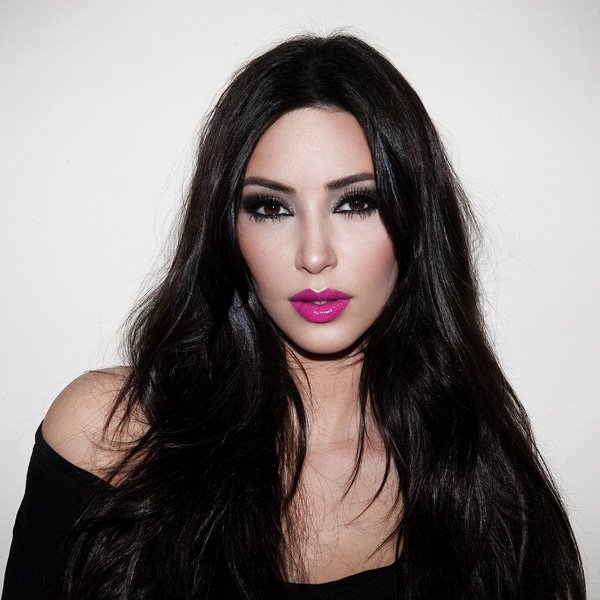 Kim Kardashian in pink lipstick and black hair.